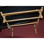 A Victorian pine towel rail; together with a white painted towel rail (2)