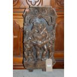 An Eastern stained and relief carved hardwood panel depicting nude dancing figures, 64x30cm