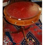 A mahogany and boxwood strung circular gilt tooled and red leather inset pedestal drum table, having