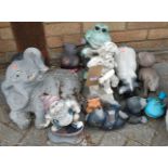 A collection of various garden ornamental animal figures