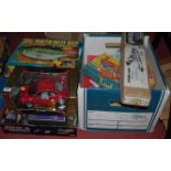 A Bburago Volkswagen Beetle, a Big Mouth Billy Bass, sky challenger, and a box of assorted games