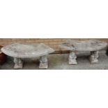 A pair of reconstituted stone curved garden benches, each raised on squirrel form end pedestals, w.