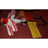A balsa wood homemade model bi-plane, painted in red and white; together with a single wingspan
