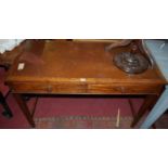 An early 20th century oak and tan leather inset two-drawer writing table, raised on square