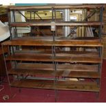 Two similar iron framed and stained wood open shelves, the largest 140 x 134cm