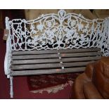 A Victorian style white painted and galvanised metal framed three-seater garden bench, with floral