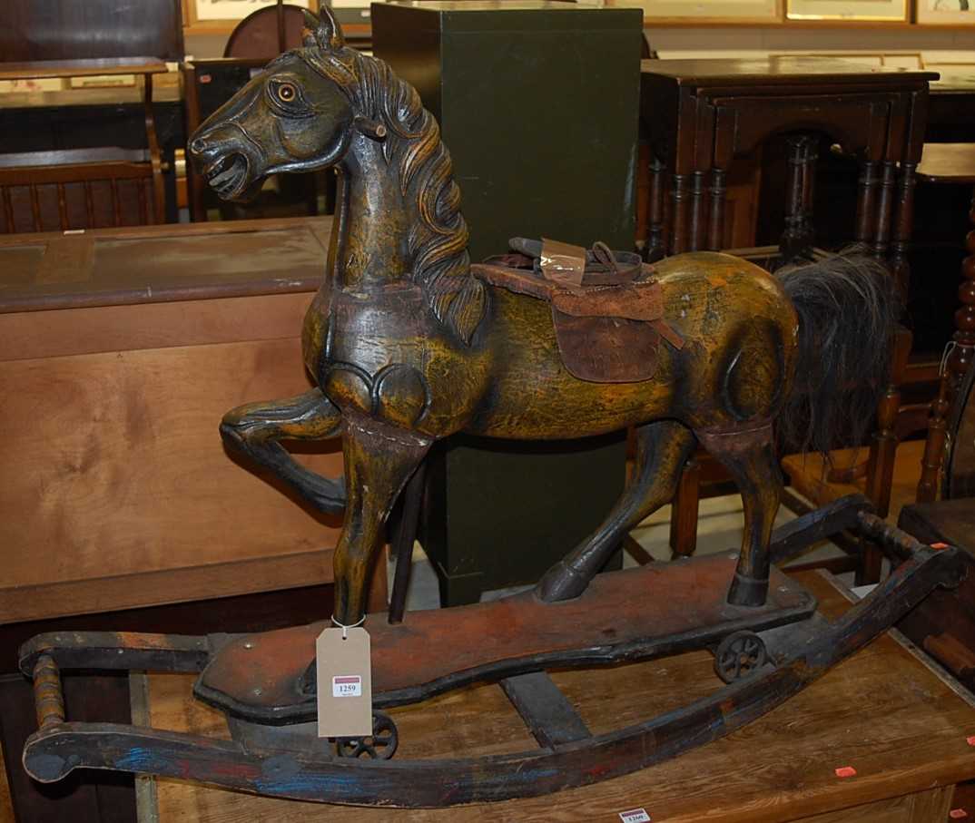 An Eastern stained and carved hardwood rocking horse raised on integral bowed stand, length 122.5cm