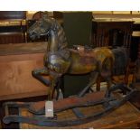 An Eastern stained and carved hardwood rocking horse raised on integral bowed stand, length 122.5cm