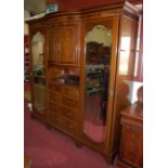 An imposing circa 1900 mahogany floral satinwood inlaid and further crossbanded triple wardrobe, the