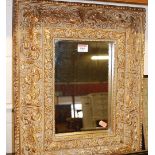 A reproduction gilt composition wall mirror, 52x41cm