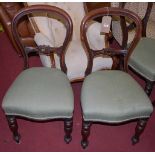 A set of six Victorian mahogany balloon back dining chairs, having green upholstered stuff over