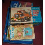 A boxed Marx cement mixer, boxed Powermight table saw, boxed Powermight Workshop, and a tinplate