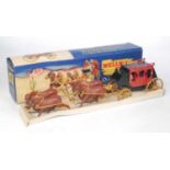 A JK Series of England Wells Fargo Stagecoach comprising of red and black stagecoach with brown