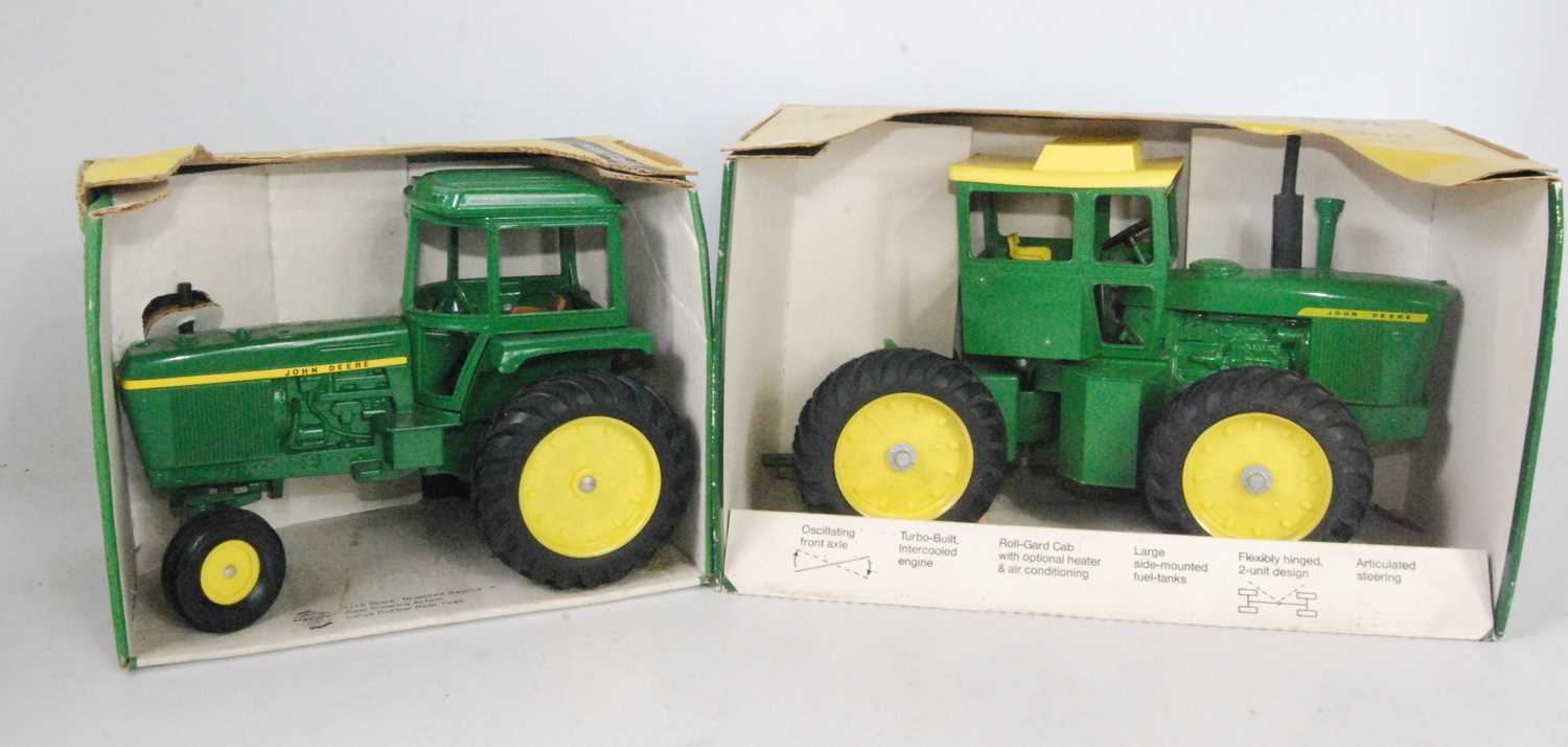 A John Deere ERTL large scale diecast group to include a John Deere Generation 2 tractor, and a 1/16