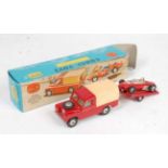A Corgi Toys gift set No. 17 Land Rover with Ferrari racing car on trailer comprising of red body,