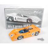 A GMP model No. 12021 1/18 scale model of a Maclaren M88 Bruce Maclaren race car, housed in the