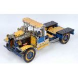 A Meccano live steam powered model of a road transport lorry constructed from blue, yellow and