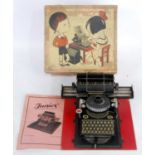 A Vintage Schmidt Brothers Junior tinplate typewriter circa 1920s comprising of black body with
