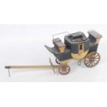 An unusual early 20th century wooden and cast iron model of a self titled The Rocket stagecoach