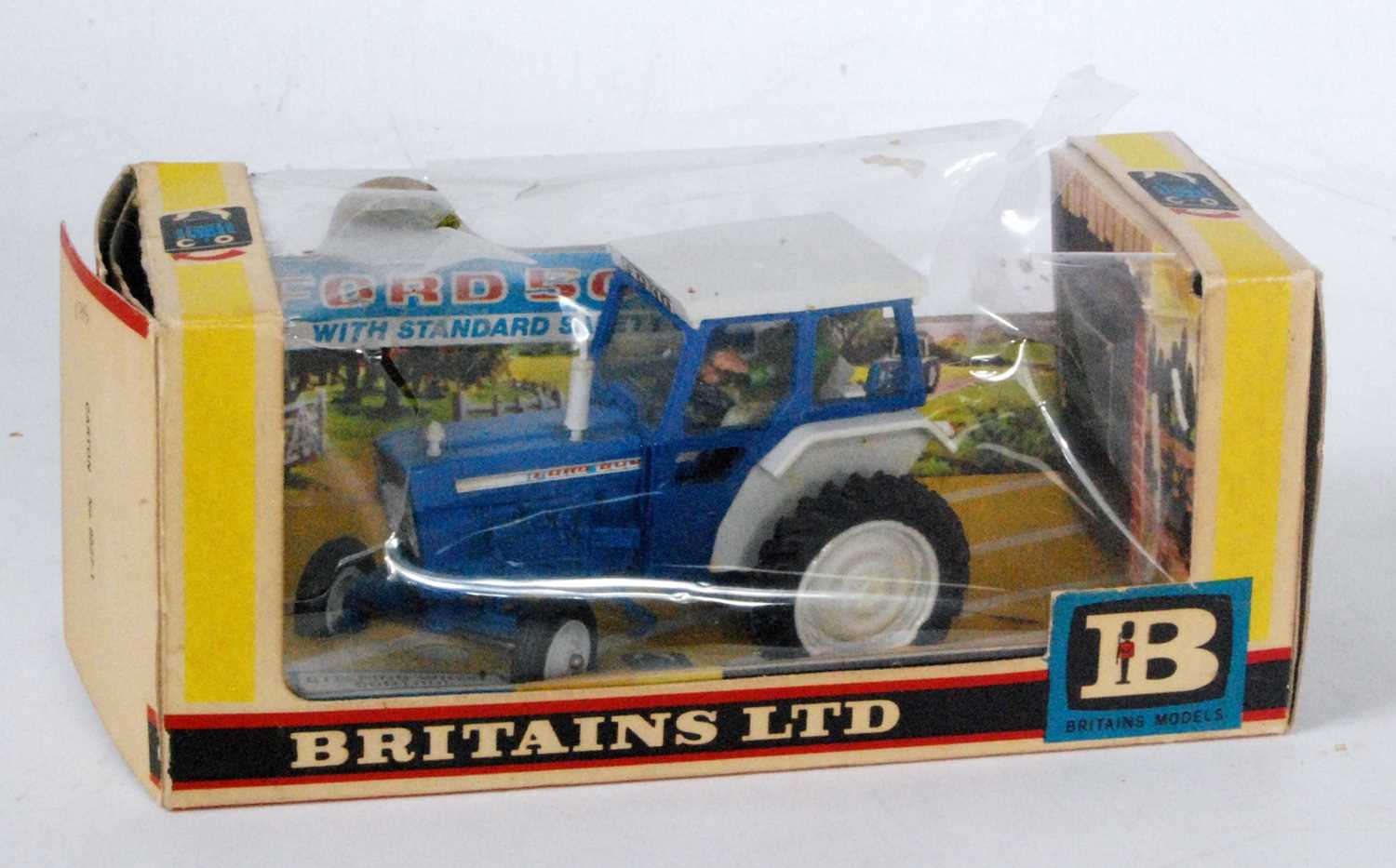 A Britains No. 9527 Ford 5000 tractor with safety cab, housed in the original window box, box in