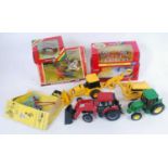 Two trays containing a quantity of various boxed and loose Britains and ERTL tractors, farm