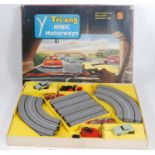 A Triang Minic Motorways No. M1504 Motorway Gift Set comprising of two cars, two hand throttles, and