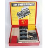 A Trix Twin Railway red box containing parts for an operating mineral train, 3 hopper wagons,