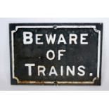 A original cast iron 'Beware of Trains' sign, dimensions 56cm x 38cm, original white on black