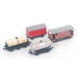 Four Hornby Dublo wagons: UD milk tank, all high stanchions (E), Esso silver tank, plastic spoked