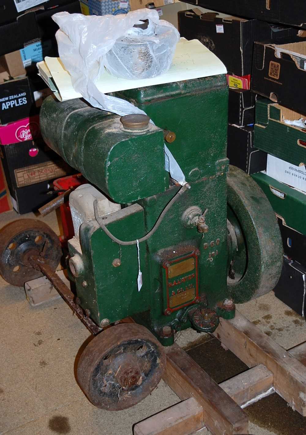 A RA Lister & Co. model No. 26DH petrol engine, raised on wooden display base with a box of