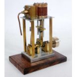 A stationary model of a live steam vertical single cylinder steam engine constructed from gunmetal