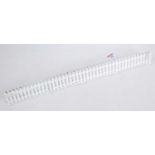 Five lengths Hornby paled fencing, comprising 4 white repro (M) and one cream original, noticeably