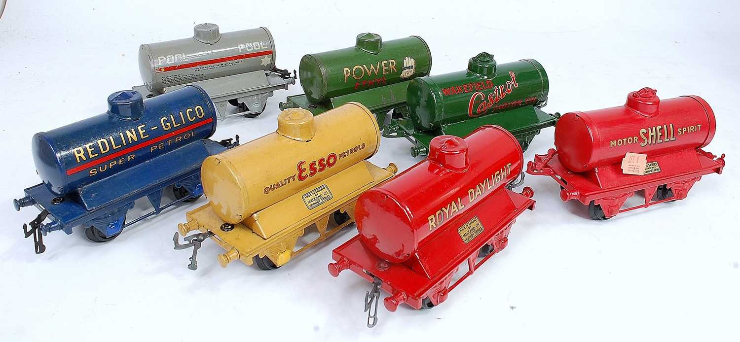 Seven assorted Hornby pre-war tank wagons:- Esso Buff, Redline Glico, Castrol, Power Ethyl, Pool,