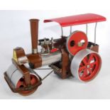 A Wilesco Old Smoky steam roller finished in brown base metal and red with burner and canopy,