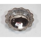 A George V silver sweetmeat dish, of shaped circular form, having repousee C-scroll decoration,