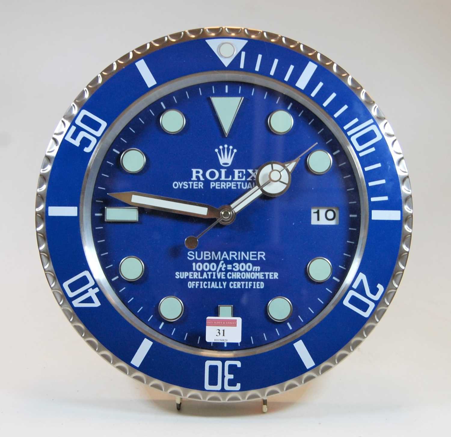 A contemporary brushed aluminium wall clock in the manner of a Rolex Submariner watch dial, with