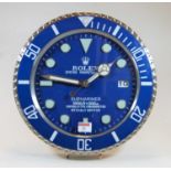 A contemporary brushed aluminium wall clock in the manner of a Rolex Submariner watch dial, with