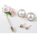 A pair of 9ct gold backed split pearl ear studs, dia.16mm; together with a porcelain tie-pin; and
