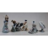 A collection of three Lladro Spanish figures, to include Pierrot with puppy, sleepy kitten, and