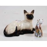 A Royal Doulton model of a Siamese Cat, in recumbent pose; together with a Royal Crown Derby desk