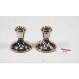 A pair of mid-20th century silver dwarf table candlesticks, each on loaded base, h.6cm
