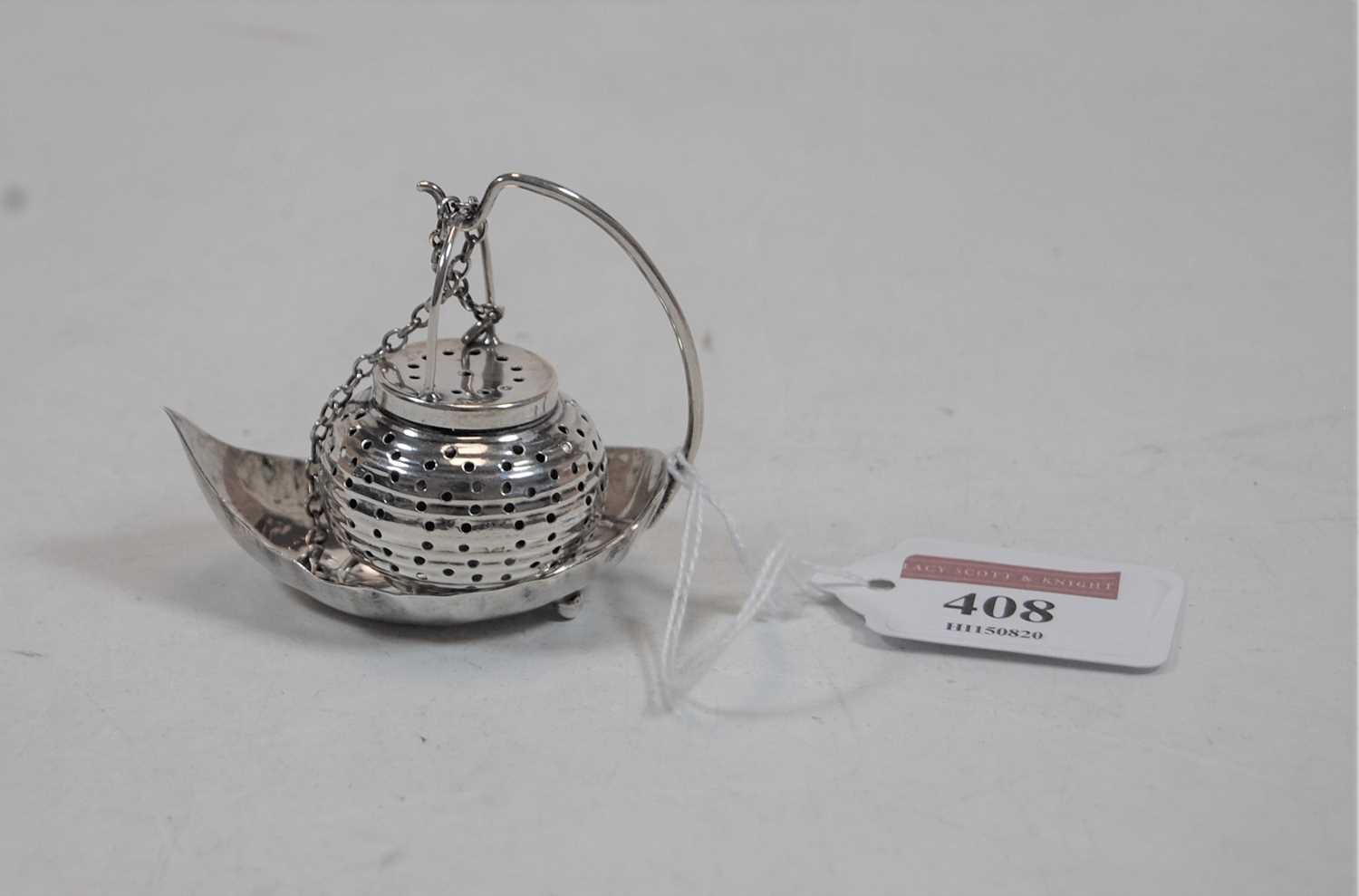 A miniature sterling silver pomander, on leaf shaped stand, stamped sterling, 0.7oz