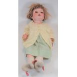 An Armand Marseille bisque head doll having rolling blue eyes and open mouth with two top teeth