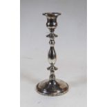 An early 20th century sterling silver table candlestick, of typical knopped form to a circular