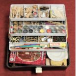 A collection of artists equipment in a concertina plastic box to include various paints, brushes,