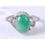 A 14ct white gold cabochon jade and twin diamond highlight set dress ring, 4g, size L/M