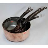 Eight 19th century copper saucepans of varying sizes each with iron handles, dia. of largest 32cm