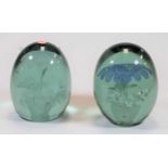 A Victorian glass dump or desk weight having flower inclusions in blue and green glass, height 12.