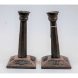 A pair of Arts & Crafts flaring octagonal oak candlesticks on carved square bases, height 23cm