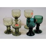 A pair of early 20th century green tinted glass wine hocks, each having decorative knopped stem